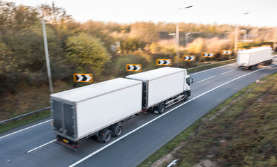 Road transport. Lorry on the road blurred in motion with focus point on the middle of the lorry.