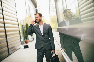 Stylish businessman walking outdoors