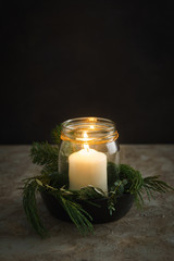 Christmas candle decoration with fir green and eucalyptus