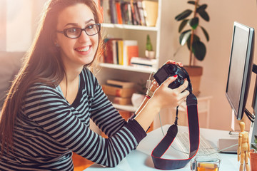 Young photographer and graphic designer at work in home office.