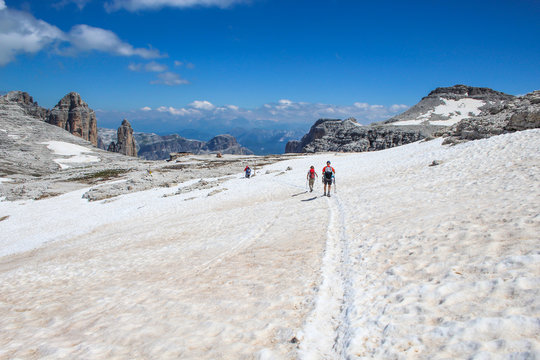 People hiking on the trails of the Sass Pordoi, Dolomites, Italy