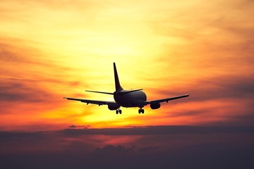 Naklejka na ściany i meble Airplane at the sunset