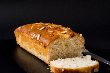 Almond cake, sliced, on black background