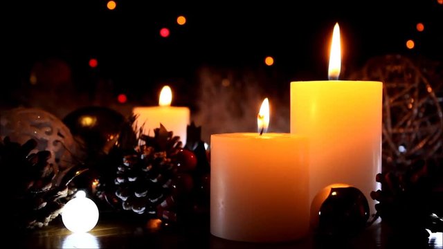 Christmas decoration background with burning candles. Burning white candles