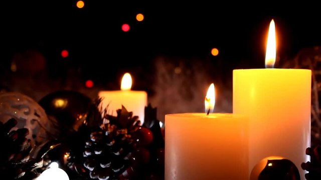 Christmas decoration background with burning candles. Burning white candles