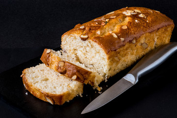 Almond cake, sliced, on black background