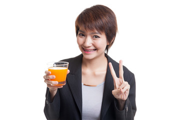 Young Asian woman show victory sign drink orange juice.