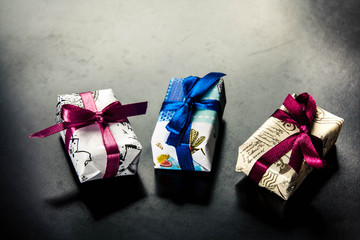 Gifts basket and candle against black background