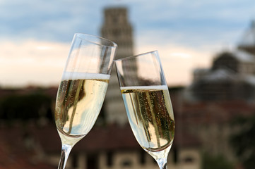 Two glasses of champagne with the Tower of Pisa in the backgroun