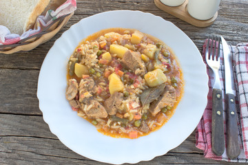Stewed pork meat with vegetables and rice in plate