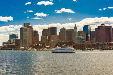 Boston skyline and ship floating across the river