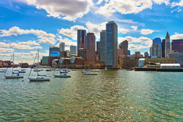 Skyline of Boston and floating boats during the sunny day