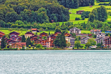 Fototapeta na wymiar Chalets at Lake Brienz and Brienzer Rothorn mountain Bern Switzerland