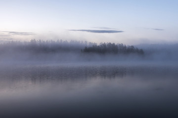 fog on the lake during sunrise in early morning in finland