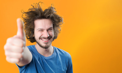 portrait of urban bearded man with funny hair against color back