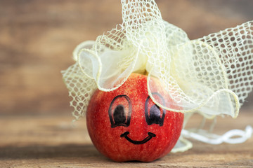 Fototapeta premium Red Apple with drawn funny face on it. 