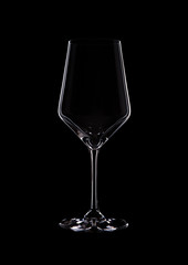 Glass of red wine with reflection on black