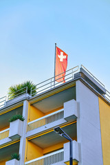 House with Swiss flag in Ascona of Ticino in Switzerland