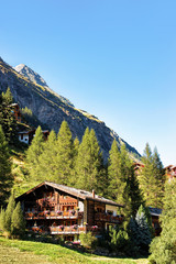 Fototapeta na wymiar Traditional Swiss chalets at resort city Zermatt