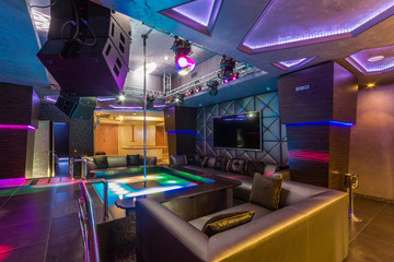 Interior of a night club with a pole