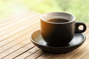Colorful wallpaper, a cup of coffee on the wooden table outdoor with special sunlight effect