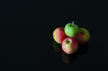 Group of fresh organic apples on a black background