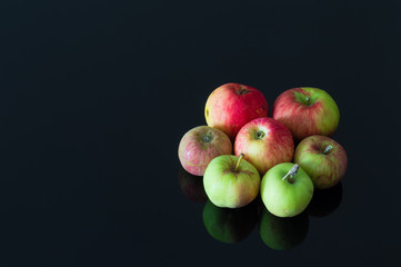 Group of fresh organic apples on a black background