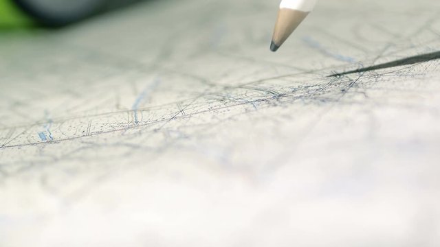 architect makes marks over a map for his job