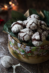 Christmas of New Year composition - a box of chocolate cookies dusted with powdered sugar; Selective focus