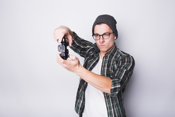 Young guy with eyeglasses holding joystick
