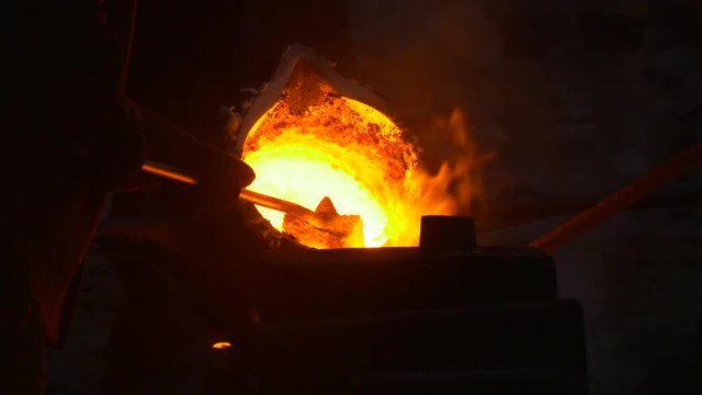 Ladle Full of Burning Orange Iron Workers Casting Molten Metal Into Molds Festival of High Temperatures in Wroclaw City Poland People Are in Safety Clothes