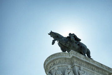 Obraz premium Bottom view of a statue of Vittorio Emanuele II in Rome. Grand marble, classical temple honoring Italy's first king & First World War soldiers.