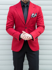 Male model posing in a red torso jacket
