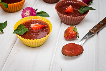 Strawberry fruit jelly with fresh berries and mint.  Dessert of jelly and berries.