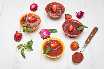 Strawberry fruit jelly with fresh berries and mint.  Dessert of jelly and berries.