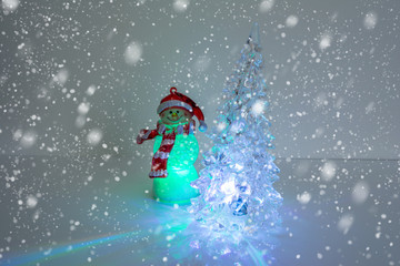 Snowman with Christmas tree on snow