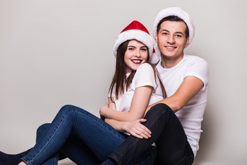 Happy hugging couple with Santa hat