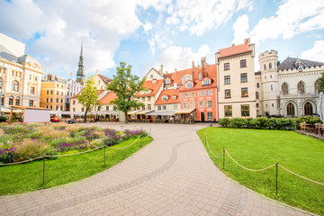 Fototapeta na wymiar Livu square with beautiful flowerbed and buildings in the old town of Riga, Latvia