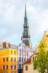Obraz premium View on the beautiful buildings with spire of saint Peter church in the old town of Riga, Latvia