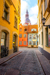 Street view with bell tower of Dome church in the old town of Riga city, Latvia
