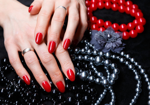 Woman hands with manicured red nails. Skin and nail care concept
