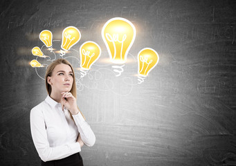 Blond woman and chain of light bulbs