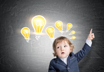 Baby boy and light bulbs on chalkboard