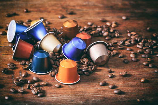 Colorful espresso capsules on wooden background