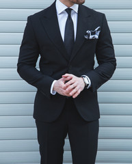 Male model posing in a black suit