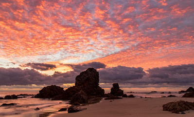 Sunrise over Flynns beach rock