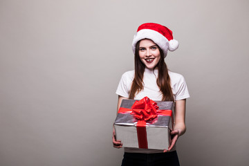 Beautiful female model wear santa hat with silence gesture