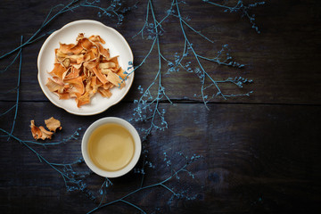 Beautiful porcelain white chinese cup of herbal tea and saucer w