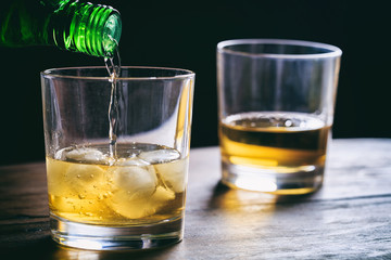 Glasses of whiskey on a wooden table