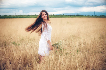 Fototapeta na wymiar Young girl on wheat field